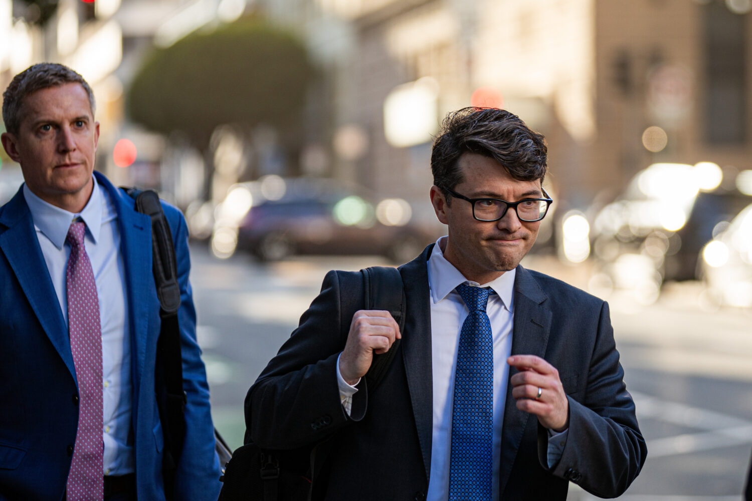 Members of Elon Musk's legal team, including attorney Stephen Broome, left, exit the Phillip Burton...