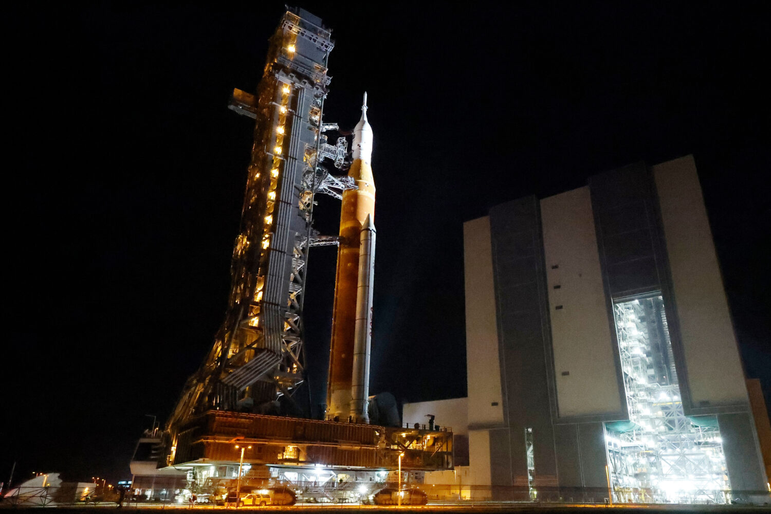 The NASA Artemis II rocket with the Orion spacecraft aboard leaves the Vehicle Assembly Building mo...