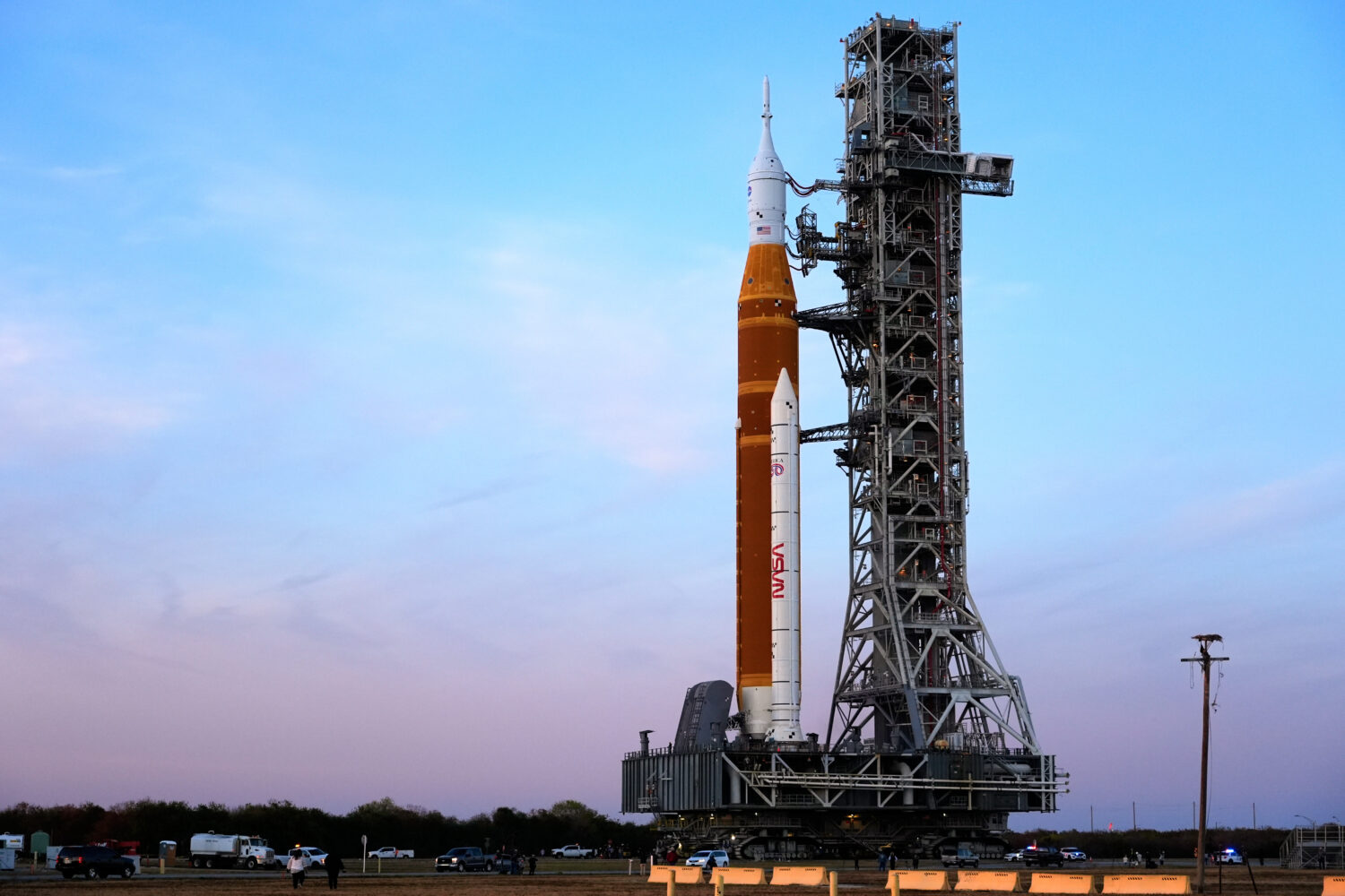 NASA's Artemis II SLS (Space Launch System) moon rocket with the Orion spacecraft slowly rolls back...