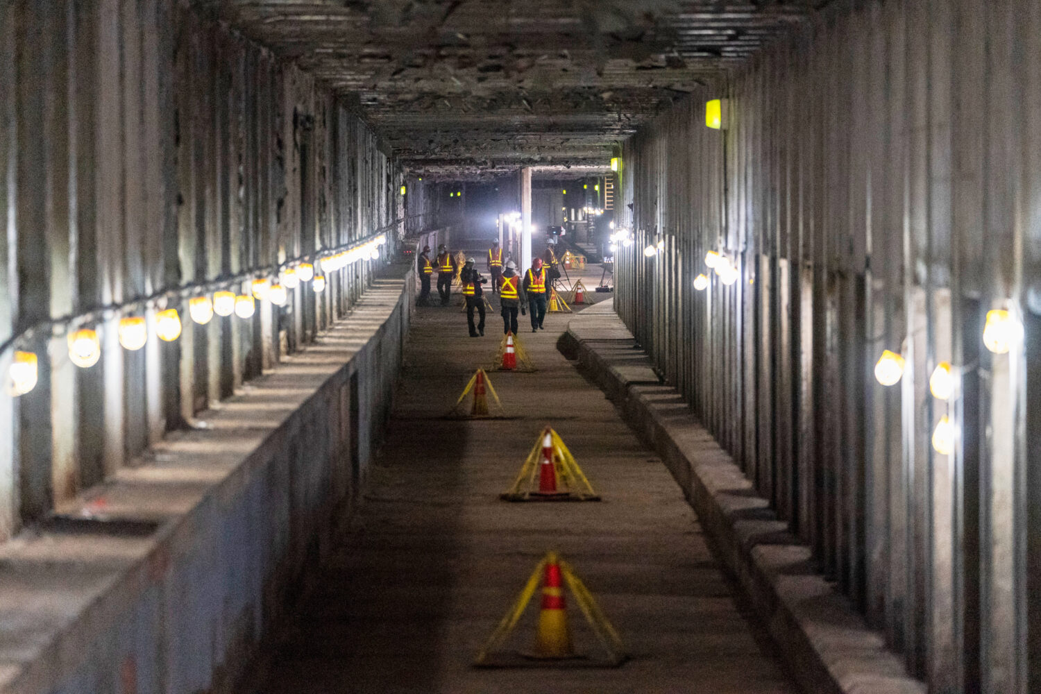 FILE - Metropolitan Transportation Authority workers are seen during a media tour of subway tunnels...