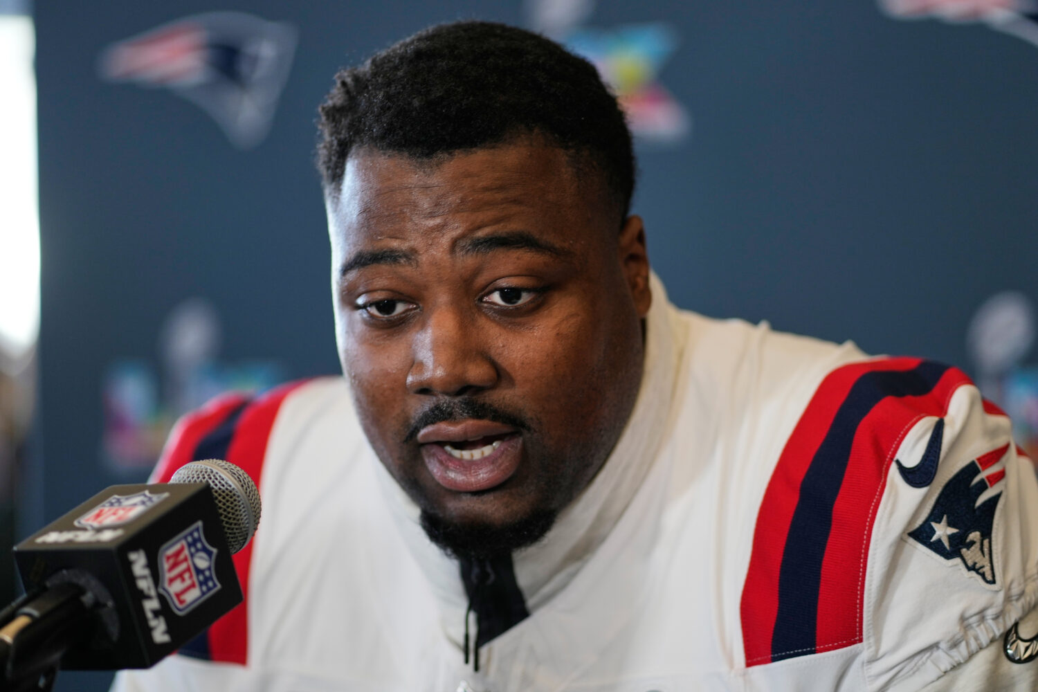 FILE - New England Patriots defensive tackle Christian Barmore talks to the media during a news con...