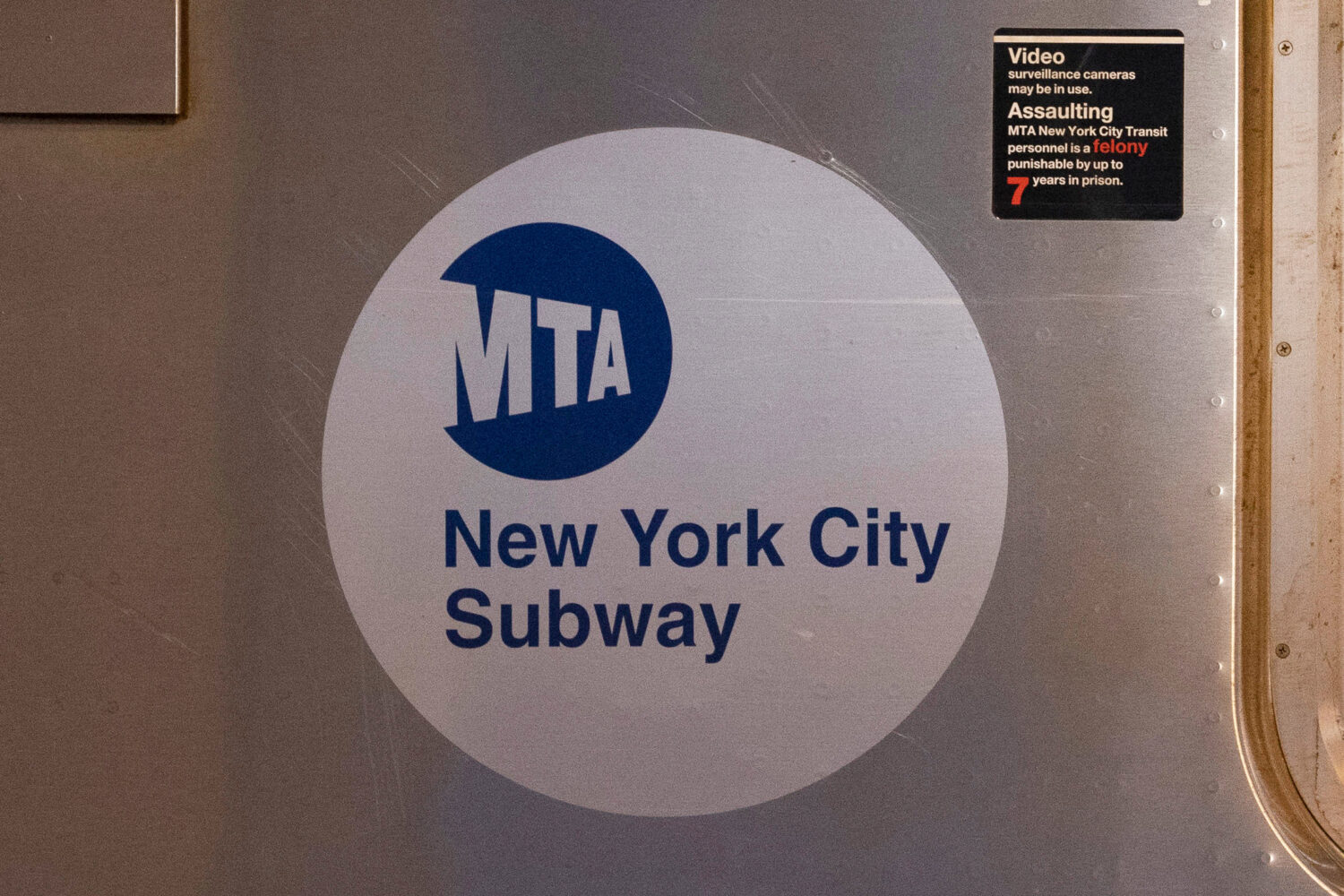 FILE - The MTA logo is seen on the side of a New York City subway car, April 23, 2020, in the Queen...
