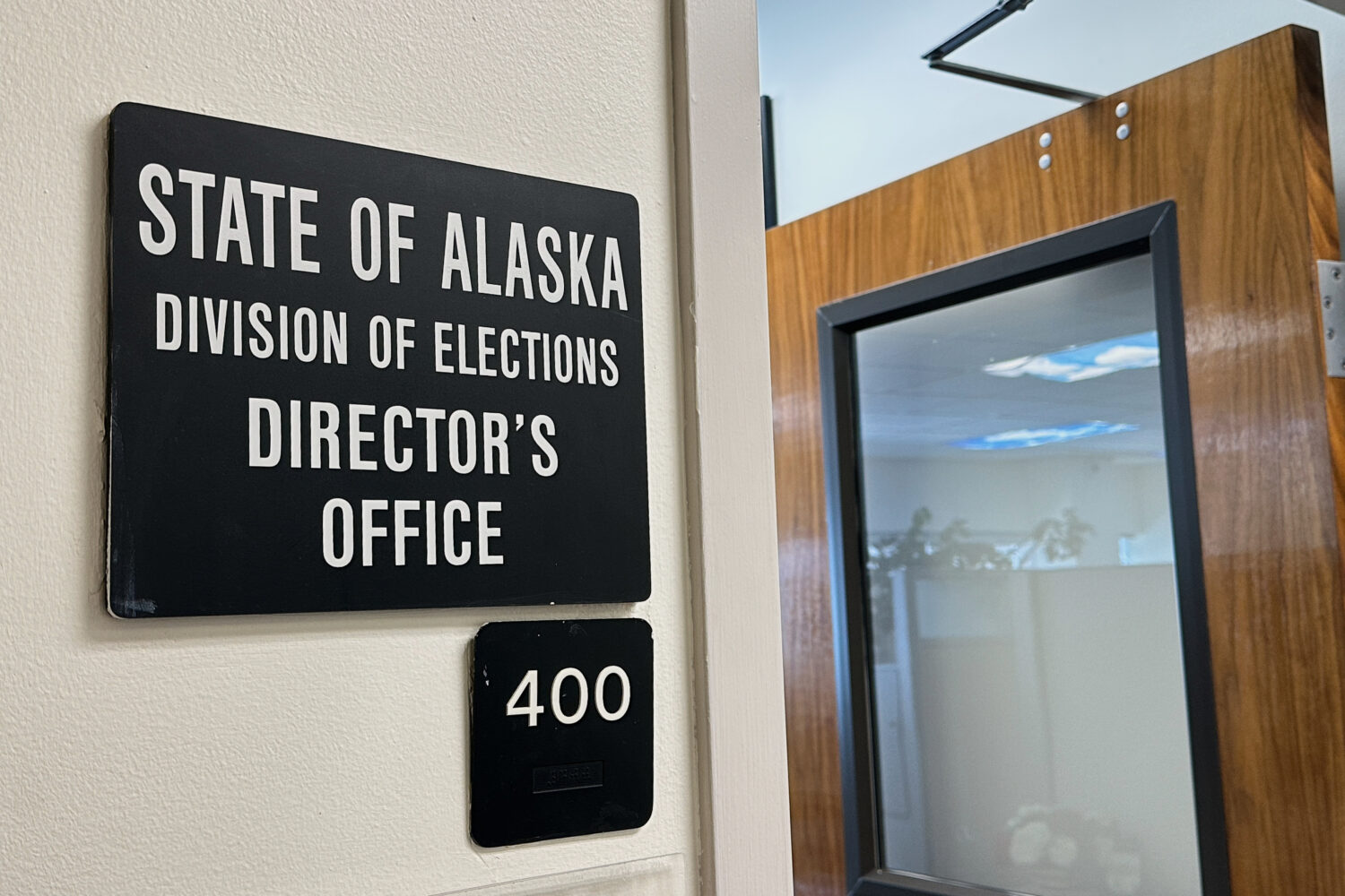 A sign hangs outside the director's office of the Alaska Division of Elections, Thursday, March 19....