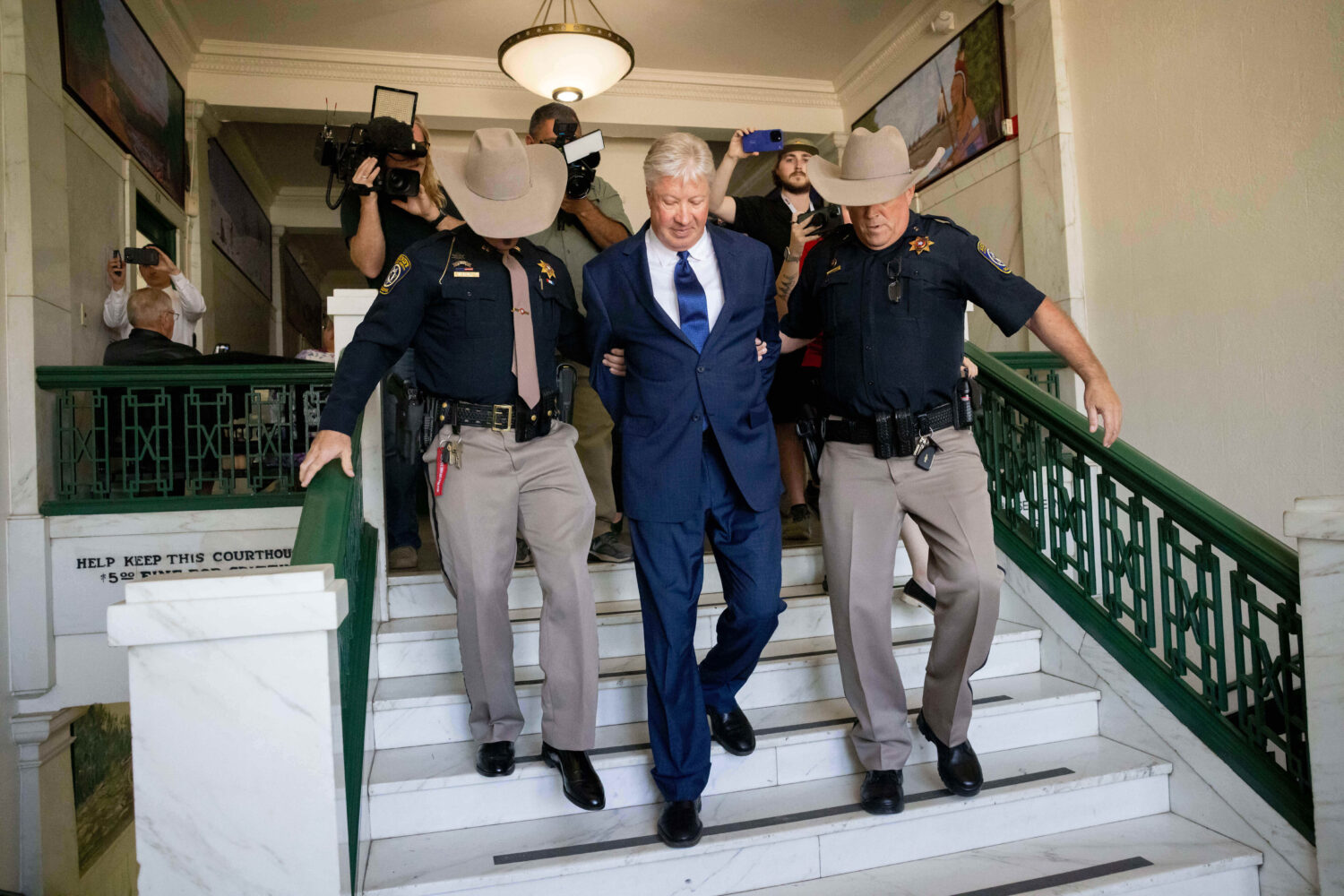 FILE - Texas megachurch founder Robert Morris is escorted out of the building after pleading guilty...