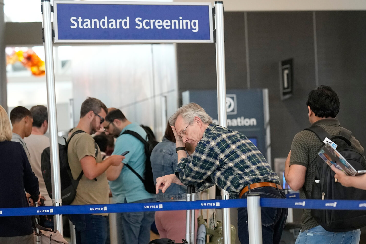 Travelers wait in long security checkpoint lines at George Bush Intercontinental Airport Friday, Ma...