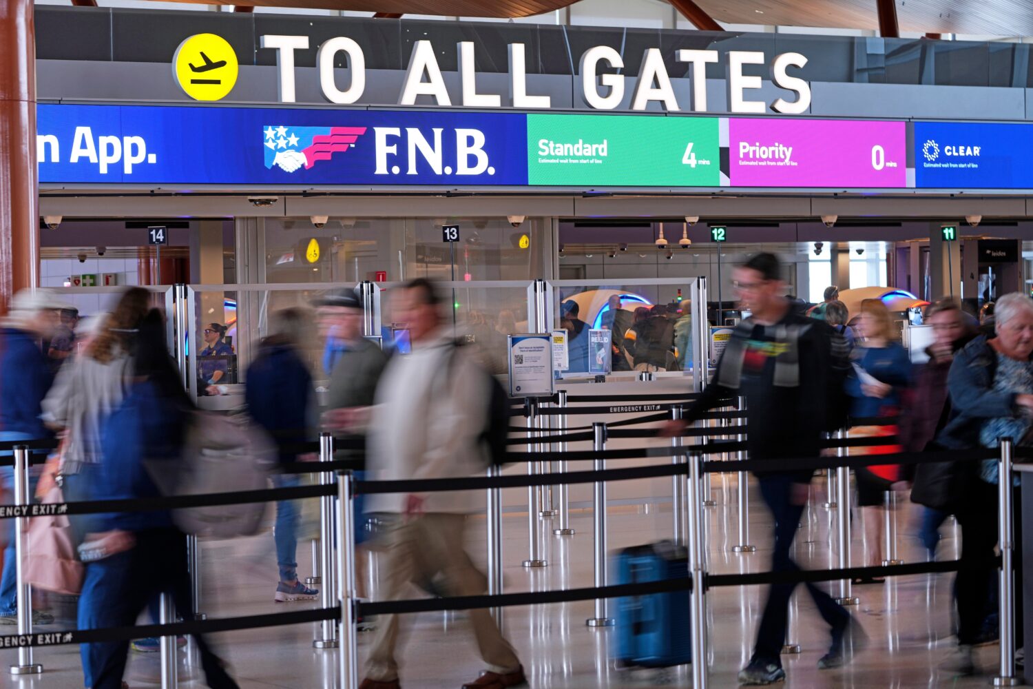 Airline travelers make their way through a TSA checkpoint queue at Pittsburgh International Airport...