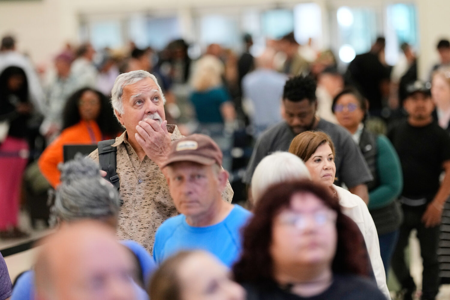 Passengers wait in a security checkpoint line at George Bush Intercontinental Airport, Wednesday, M...