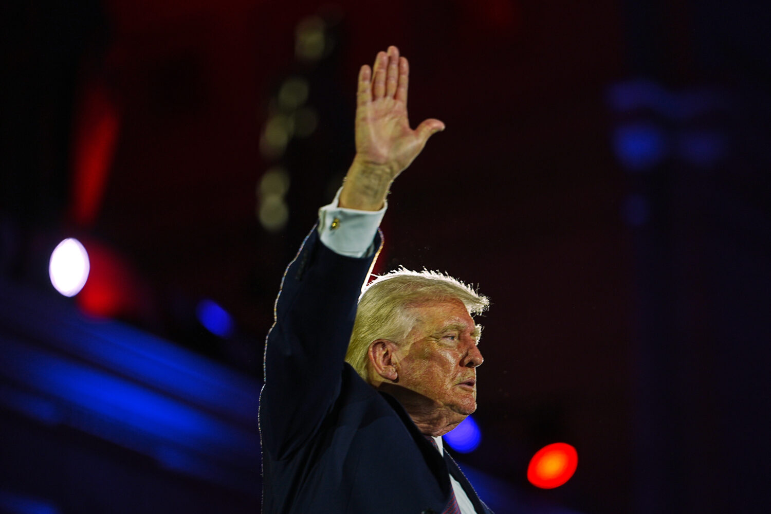 President Donald Trump waves after speaking at the National Republican Congressional Committee's (N...