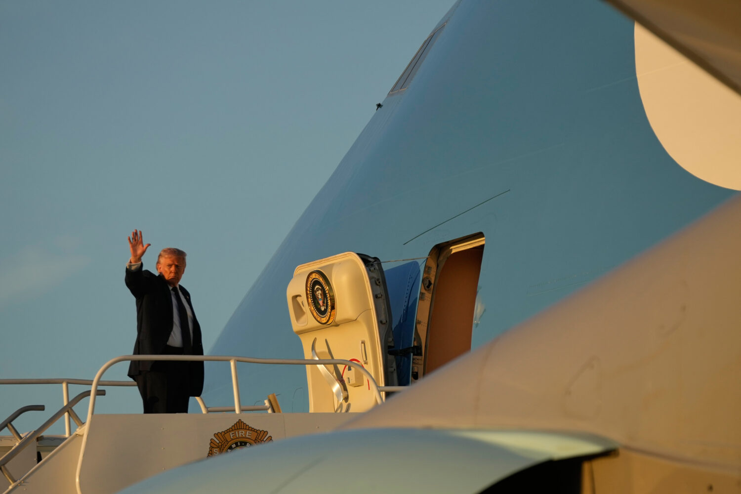 President Donald Trump waves as he boards Air Force One, Monday, March 9, 2026, at Miami Internatio...
