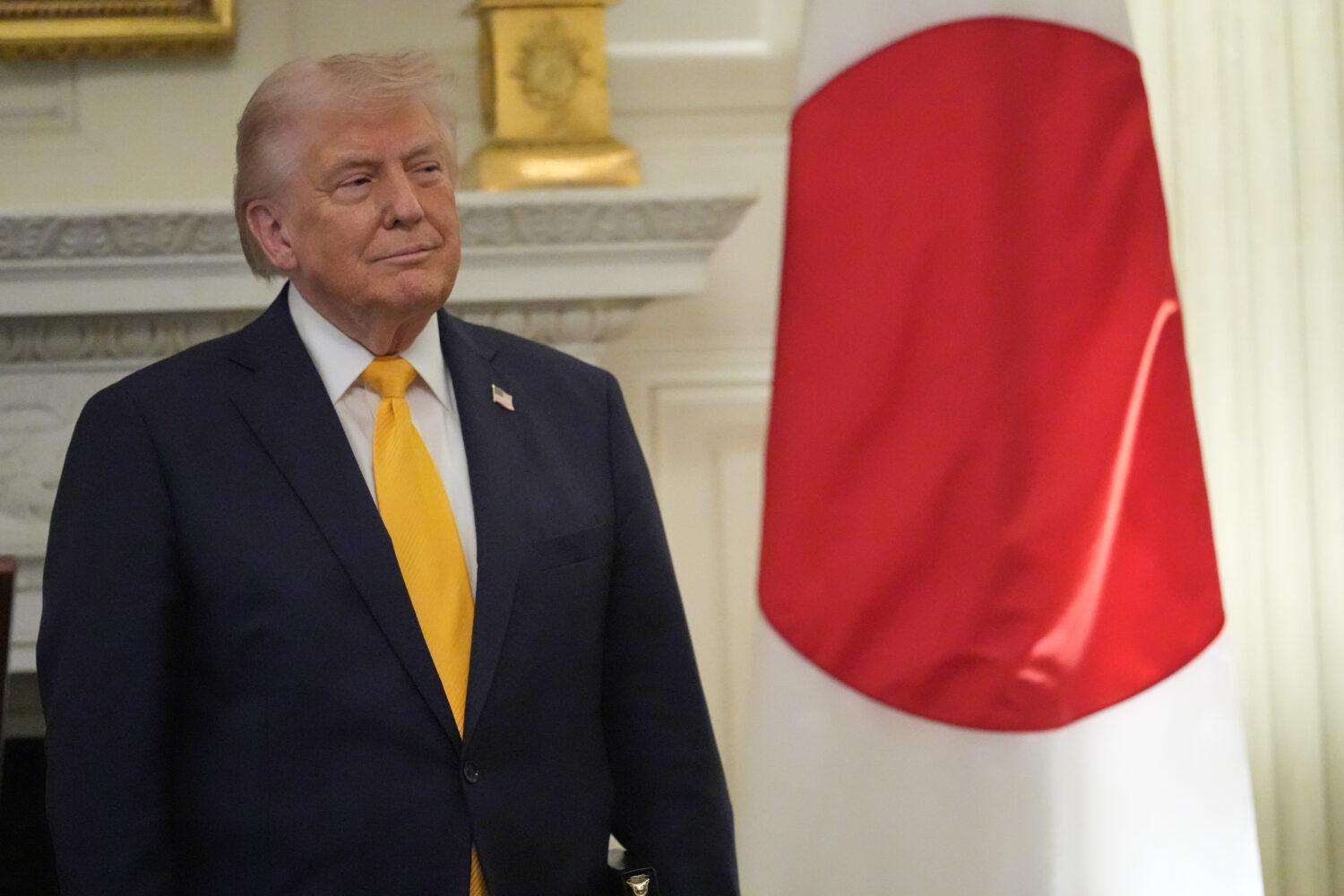 President Donald Trump listens as Japan's Prime Minister Sanae Takaichi speaks during a dinner in t...