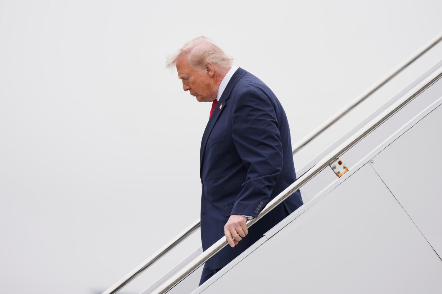 President Donald Trump steps off Air Force One, Saturday, March 7, 2026, at Dover Air Force Base, D...