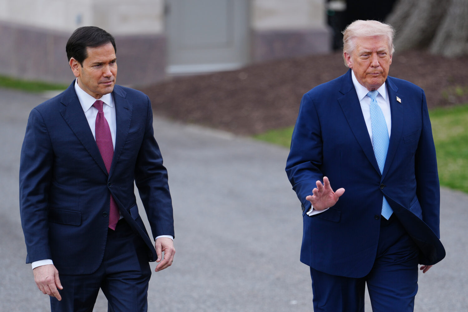 President Donald Trump walks with Secretary of State Marco Rubio to speak with reporters before dep...