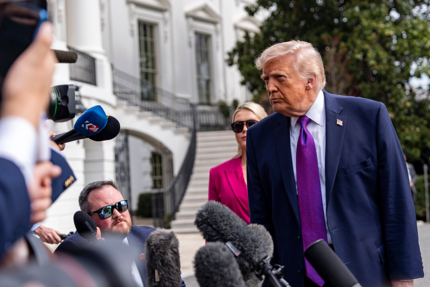 President Donald Trump speaks with reporters before departing on Marine One from the South Lawn of ...
