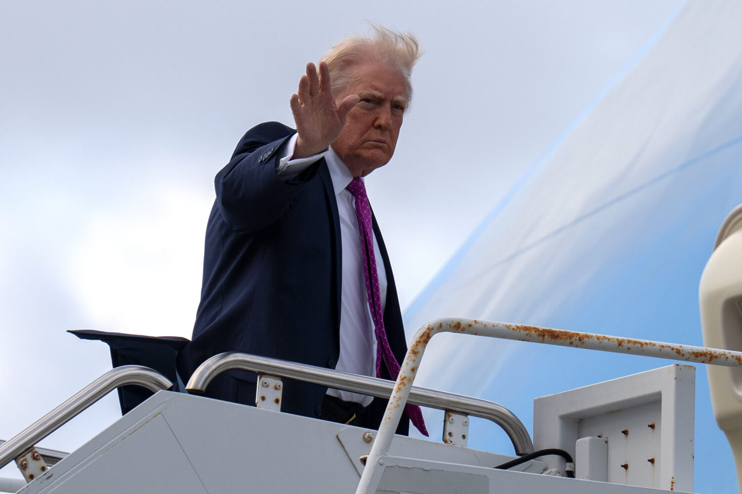President Donald Trump waves as he boards Air Force One, Sunday, March 29, 2026, at Palm Beach Inte...