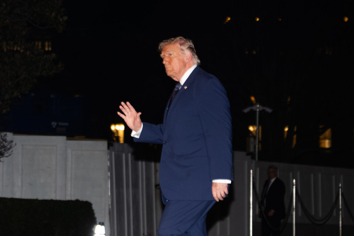 President Donald Trump waves on the South Lawn as he returns to the White House following a trip to...