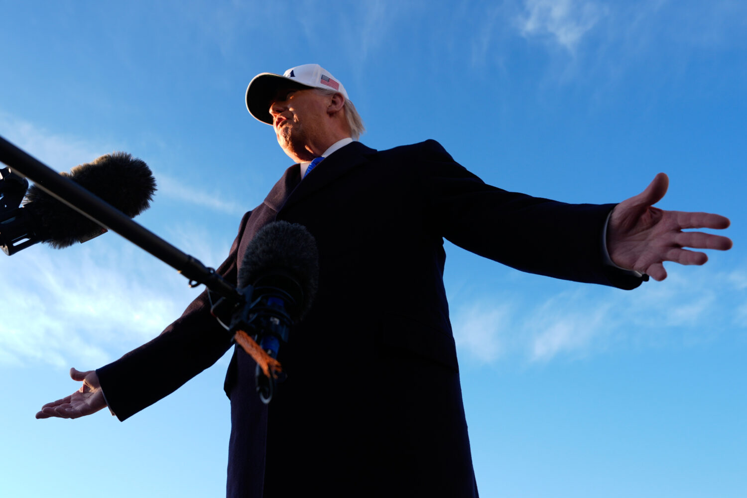 President Donald Trump speaks to reporters before he boards Air Force One, Friday, March 13, 2026, ...