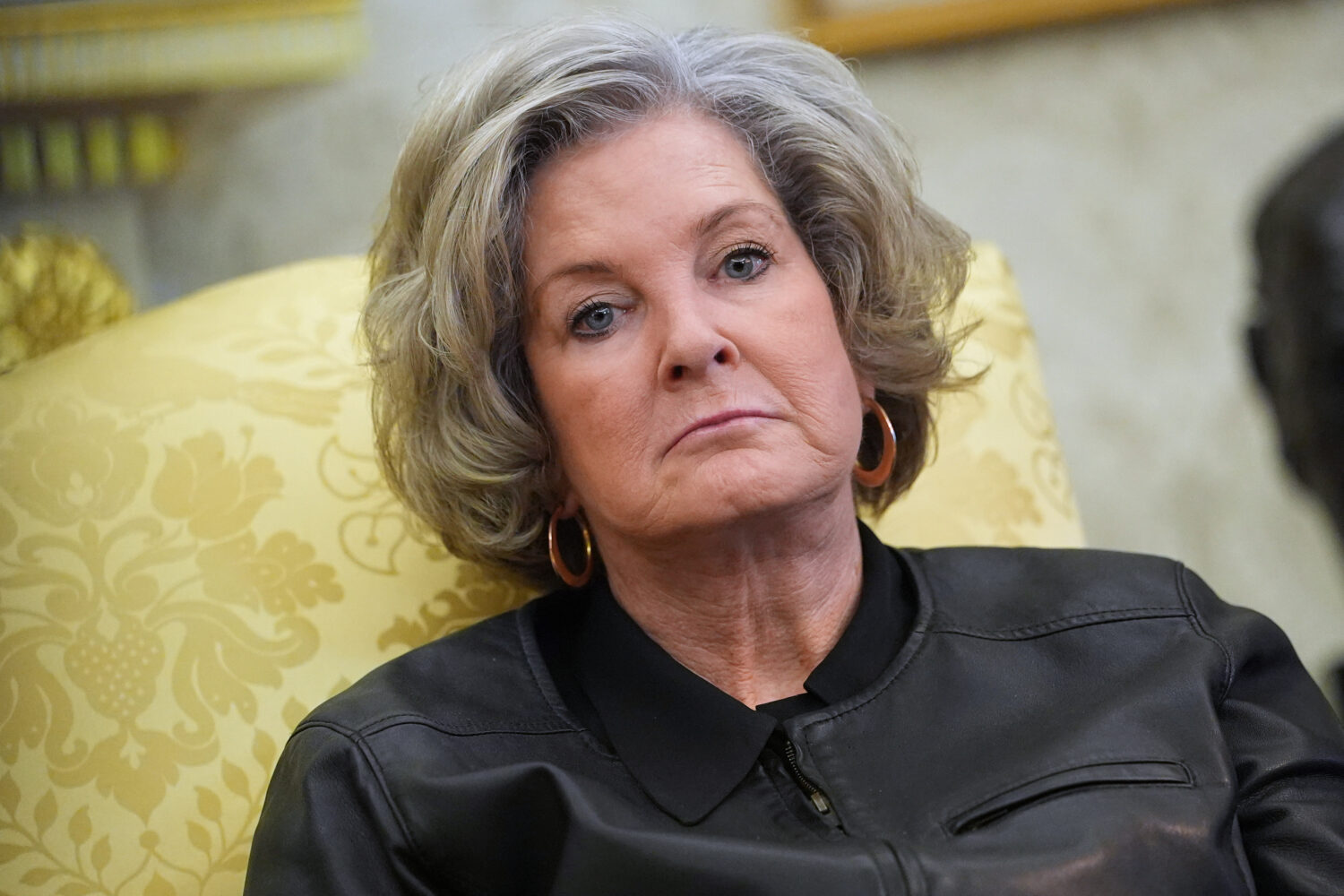 FILE - White House chief of staff Susie Wiles listens as President Donald Trump speaks to reporters...