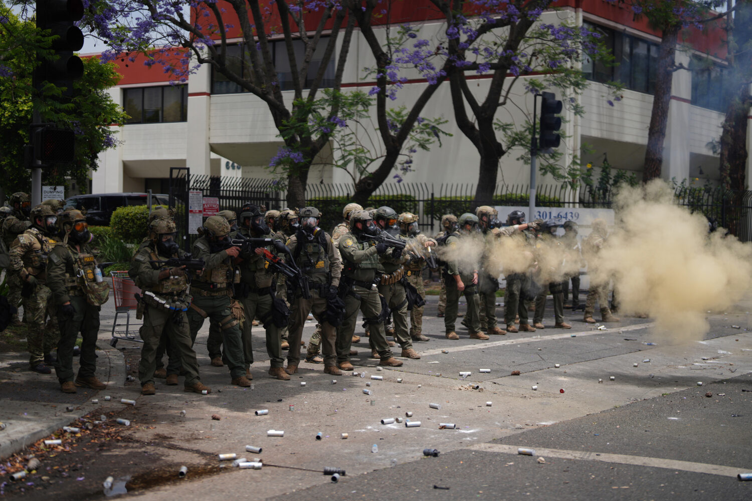 FILE - Border Patrol personnel deploy tear gas during a demonstration over the dozens detained in a...