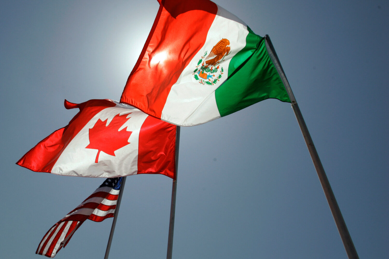 FILE - National flags representing the United States, Canada, and Mexico fly in the breeze in New O...