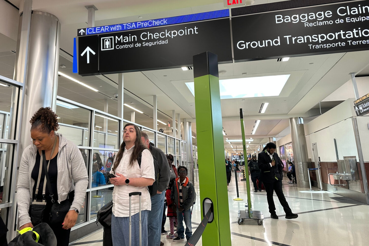 Passengers wait outside a Transportation Security Administration checkpoint at Hartsfield-Jackson A...