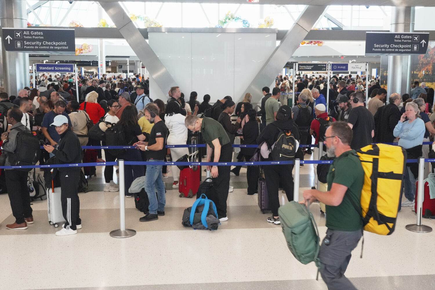 Airline passengers wait in long lines to get through the TSA security screening at George Bush Inte...