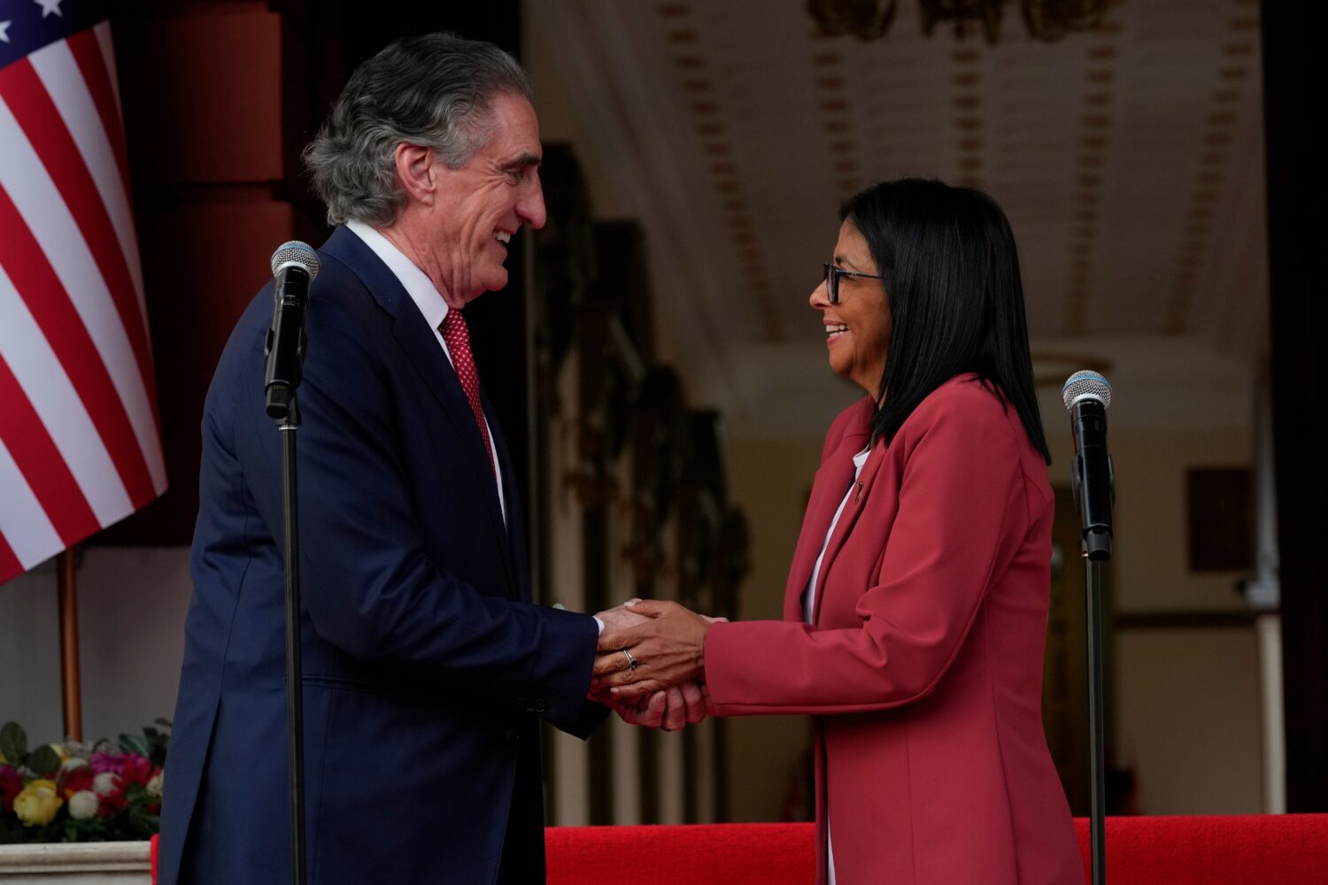 Venezuela's acting President Delcy Rodriguez, right, and U.S. Interior Secretary Doug Burgum shake ...