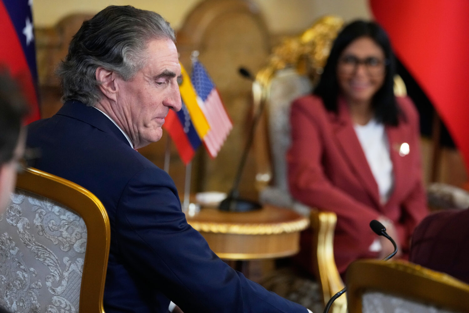 Venezuela's acting President Delcy Rodriguez, behind, and U.S. Interior Secretary Doug Burgum meet ...