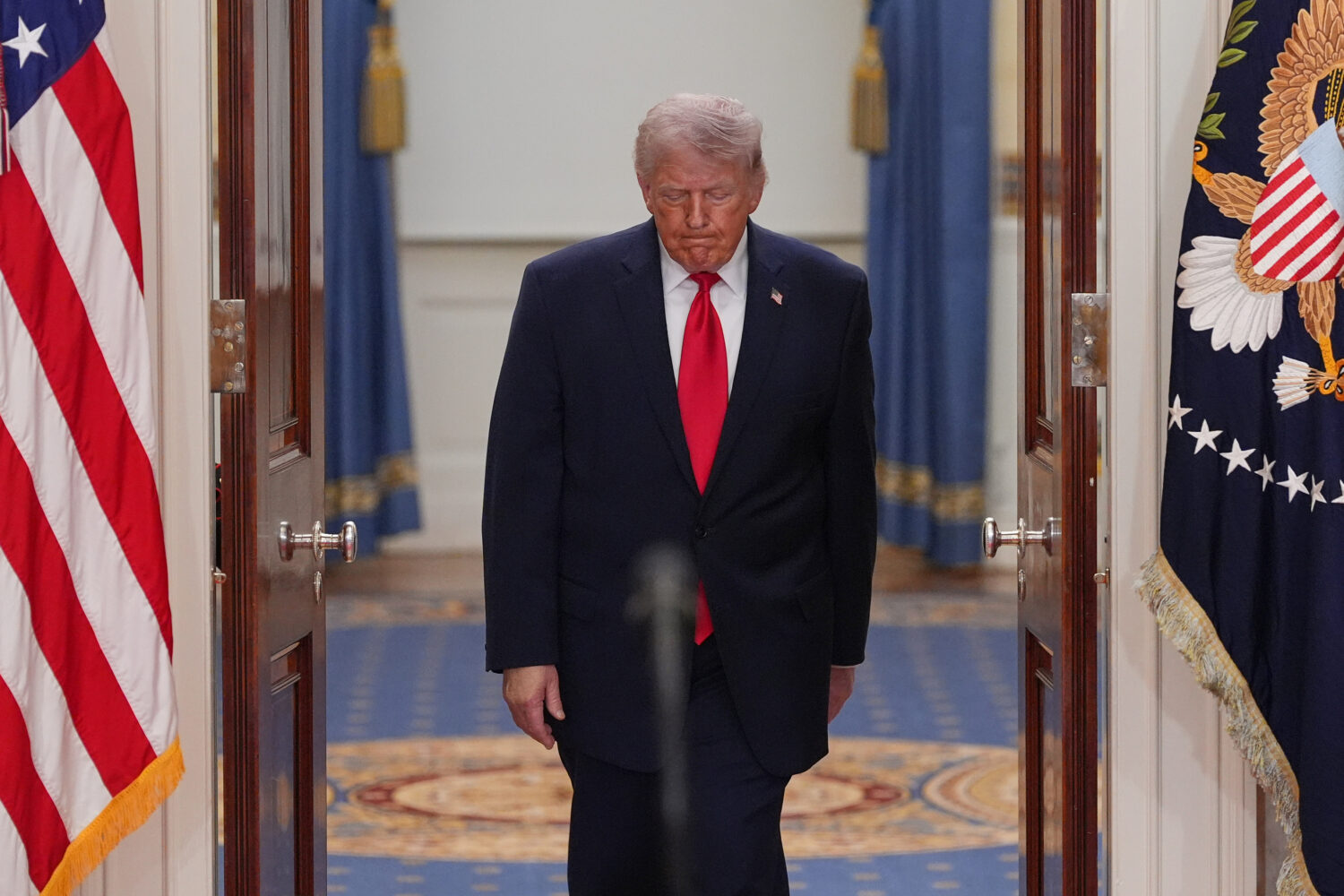 President Donald Trump arrives to speak about the Iran war from the Cross Hall of the White House o...