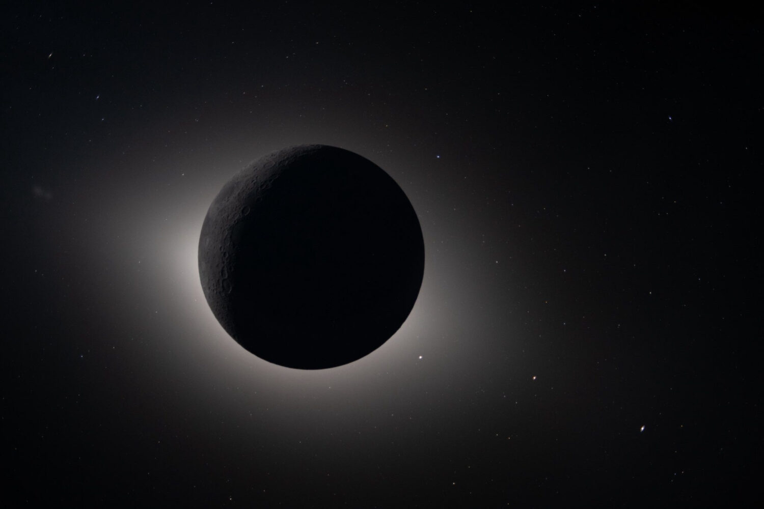 In this image provided by NASA, The Artemis II crew captured from lunar orbit, the Moon eclipses th...