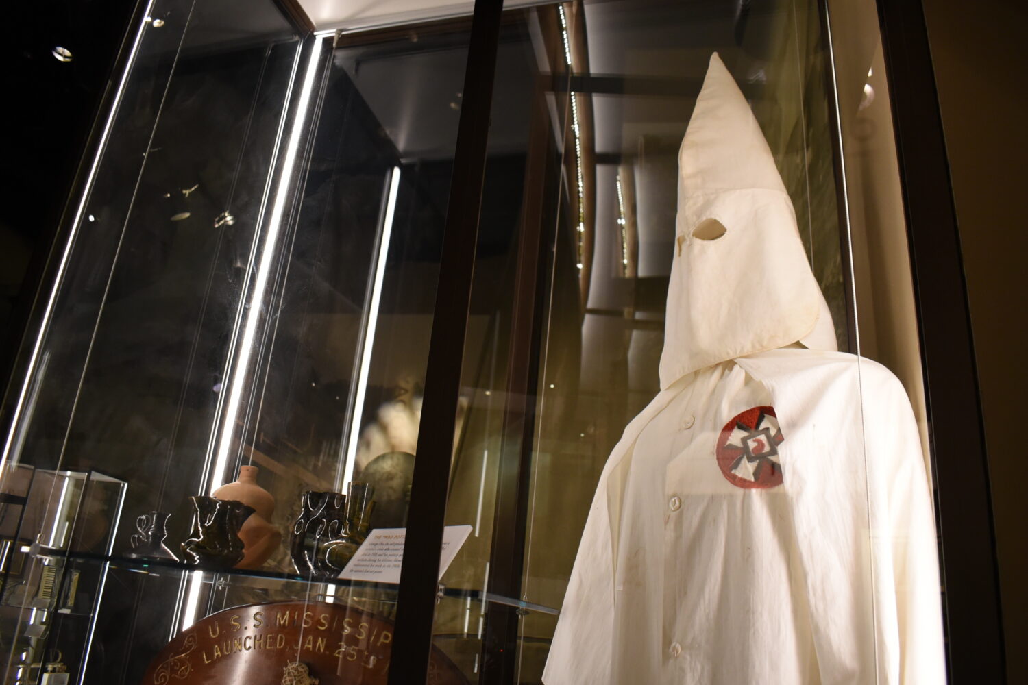 A Ku Klux Klan mask stares out over the Mississippi Museum of History on Friday, March 27, 2026, in...
