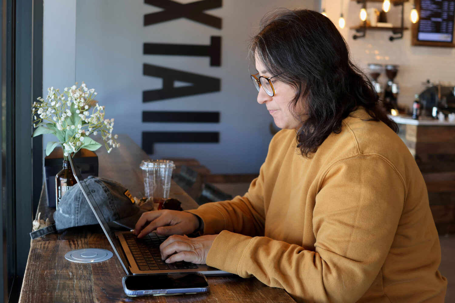 Lauren Contreras, 40, works from her laptop at Foxtail Coffee Co., in Flagstaff, Ariz., on Monday, ...