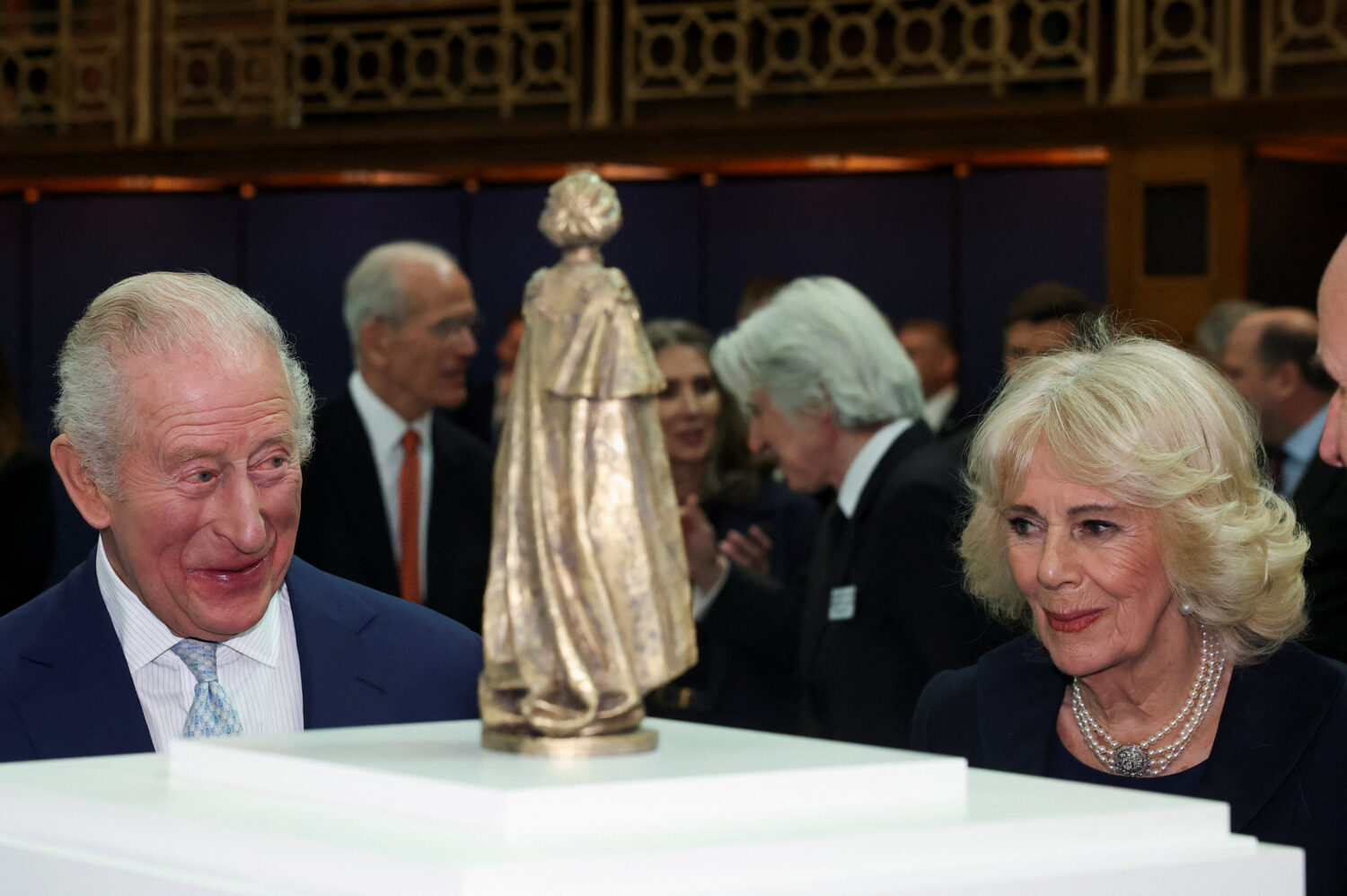 Britain's King Charles III and Queen Camilla look at a scaled model sculpture by Martin Jennings, d...