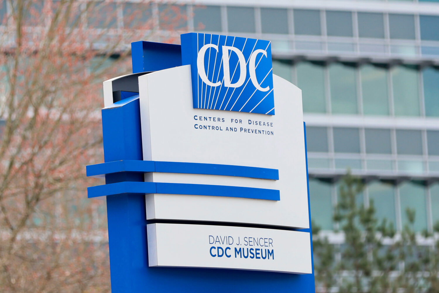 FILE - A sign with the CDC logo is displayed at the entrance to the agency's headquarters in Atlant...