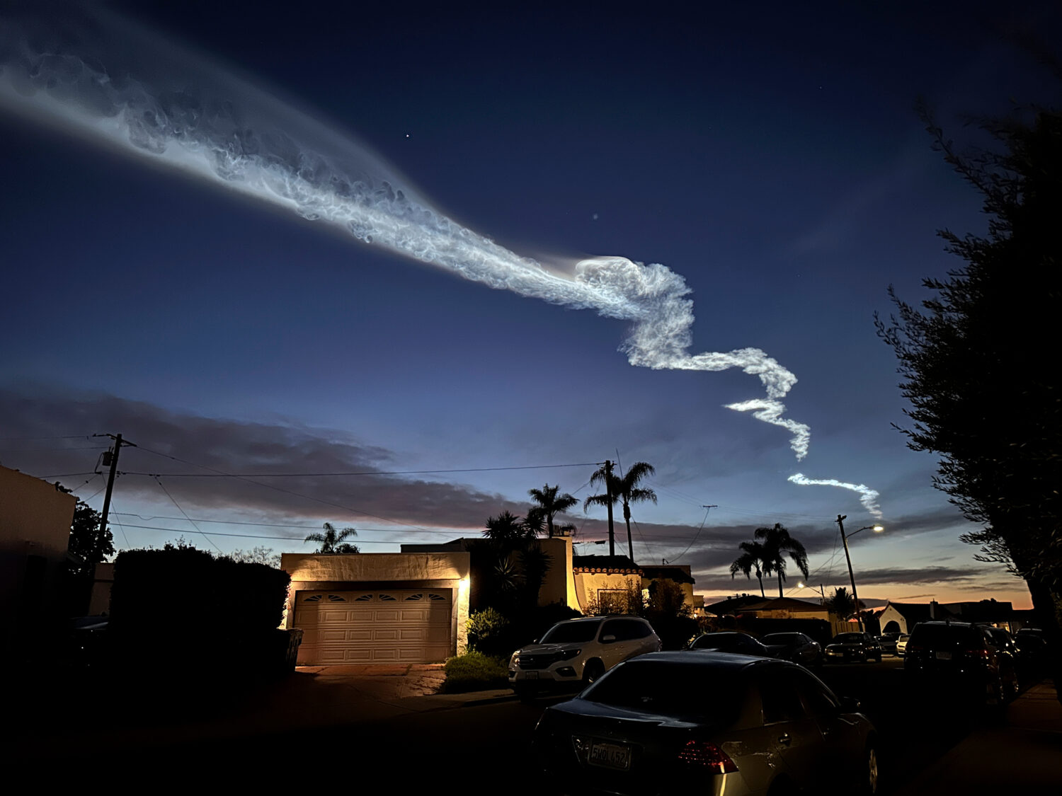 FILE - A contrail from a SpaceX Falcon 9 rocket, which launched from Vandenberg Space Force Base, i...
