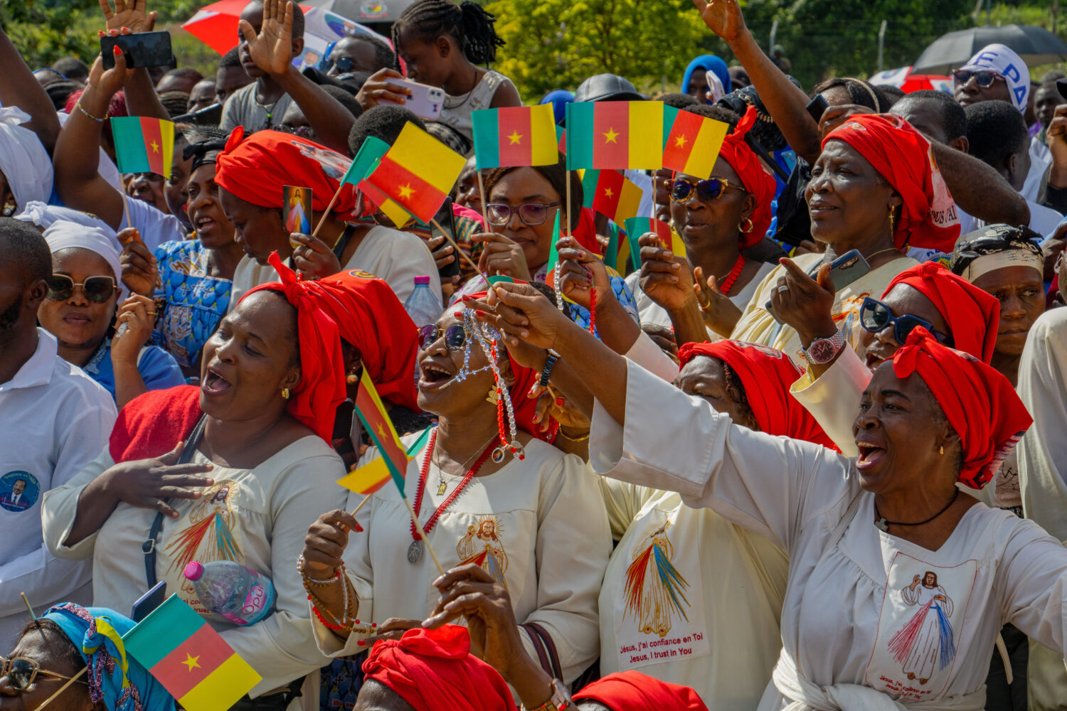 People cheer as Pope Leo XIV arrives in Yaounde, Cameroon, Wednesday, April 15, 2026. (AP Photo/Wel...