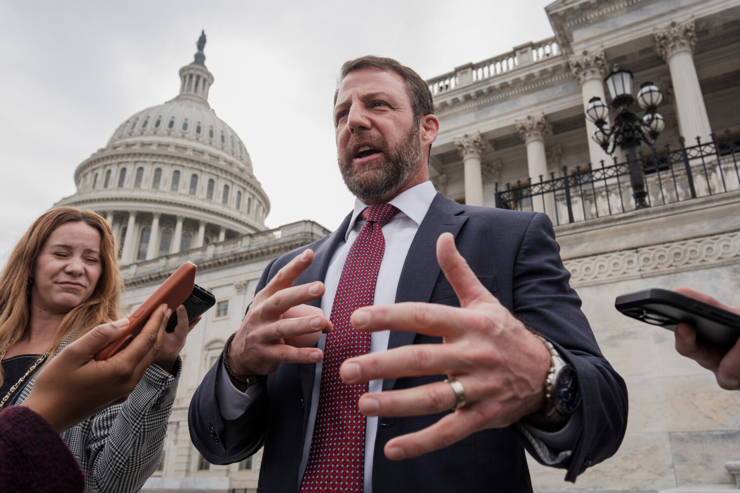 FILE - Sen. Markwayne Mullin, R-Okla., speaks with reporters on the steps at the Capitol in Washing...