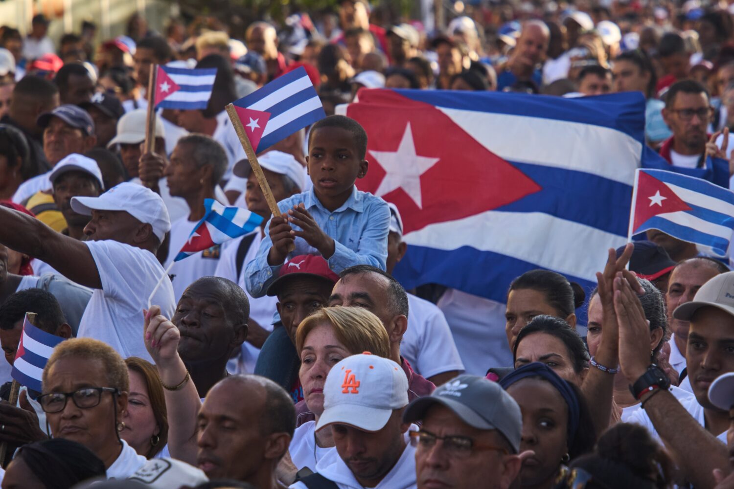 People attend a celebration marking the 65th anniversary of the proclamation declaring the Cuban Re...