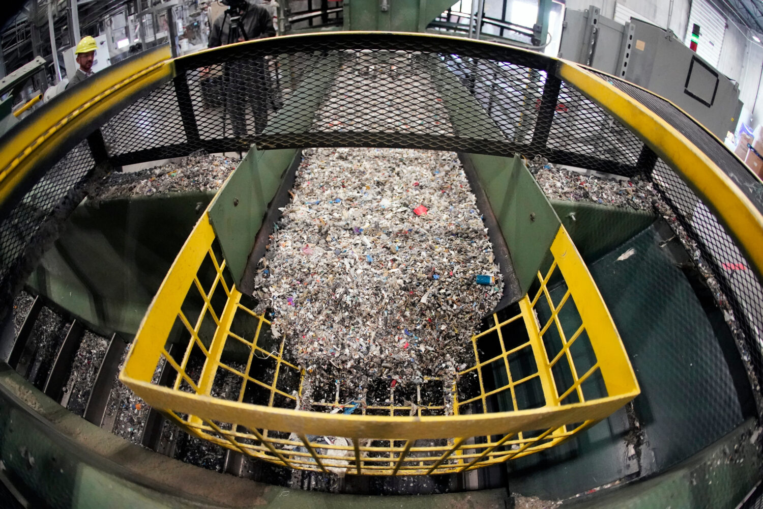FILE - Ground up plastics that Alterra Energy receives from recycling facilities, move along a conv...