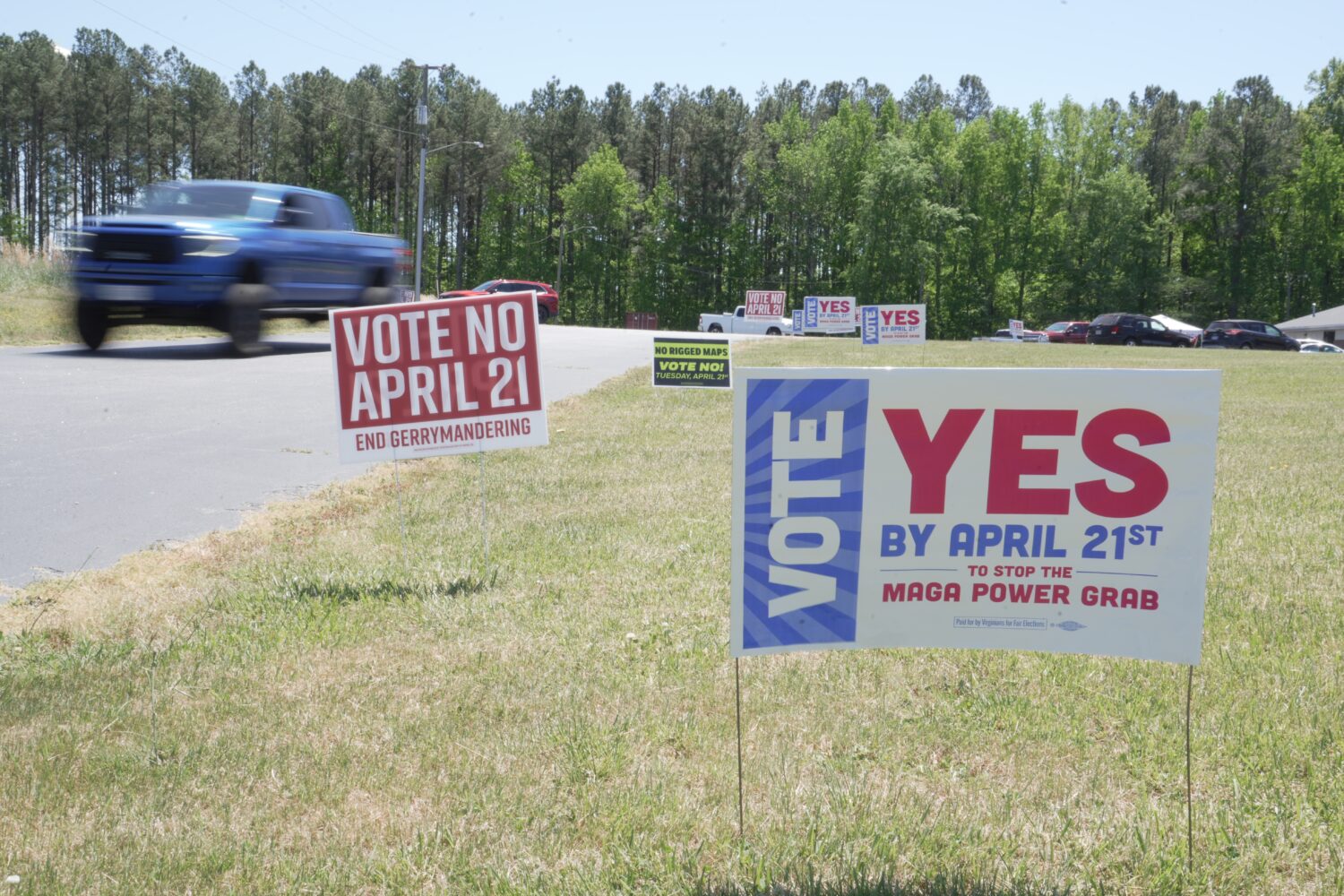A truck passes political signs outside a polling place at Good Shepherd Catholic Church in South Hi...