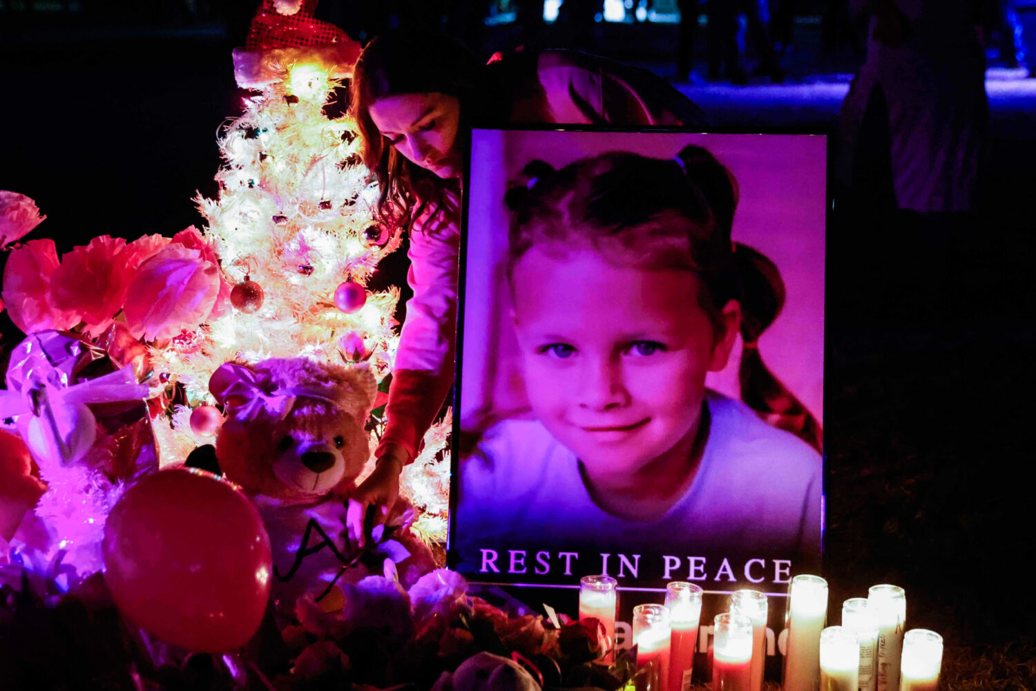 FILE - Attendees offer their respects at a makeshift memorial for Athena Strand after a memorial se...