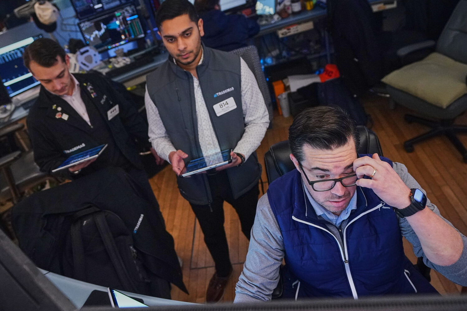 Joseph Lawler, right, works with fellow traders on the floor of the New York Stock Exchange, Thursd...