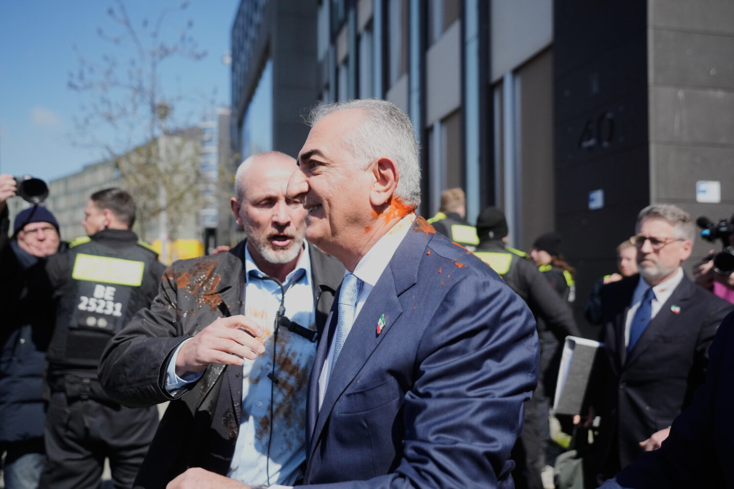Iran's Reza Pahlavi, exiled son of Shah Reza Pahlavi, is protected by security after he was attacke...