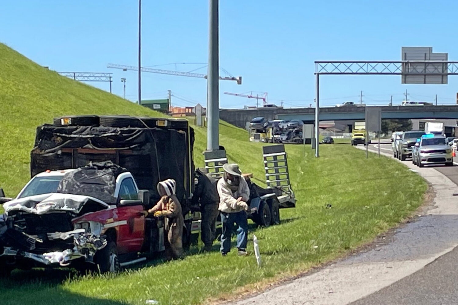 In this photo provided by the Tennessee Department of Transportation, beekeepers work to contain a ...