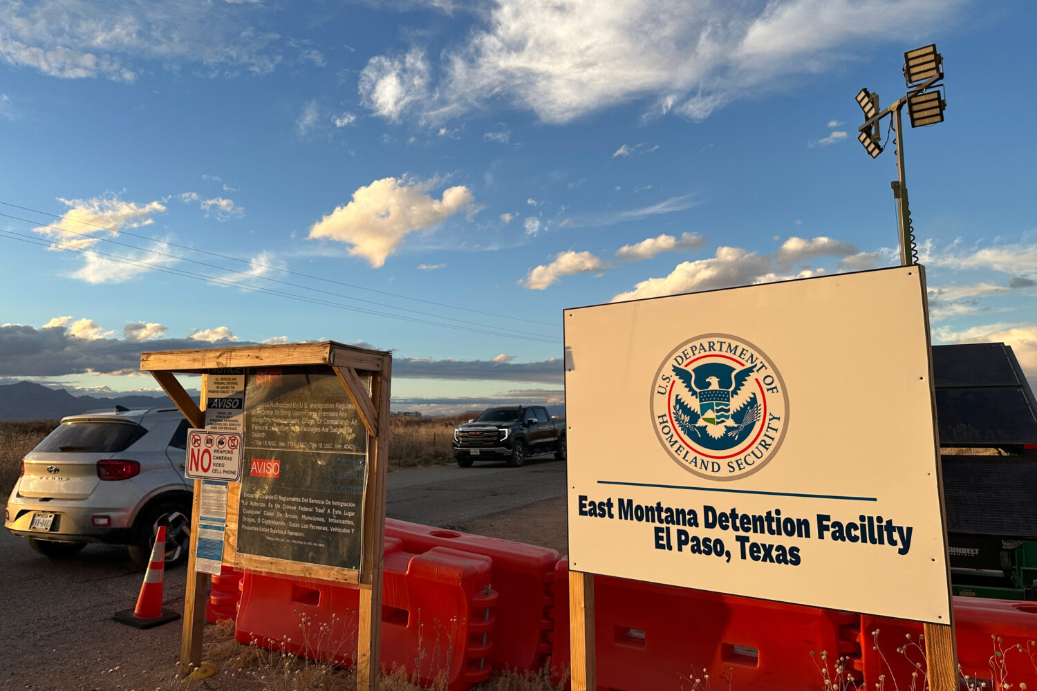 FILE - A sign marks the entrance to a series of hardened tents at the Camp East Montana immigrant d...
