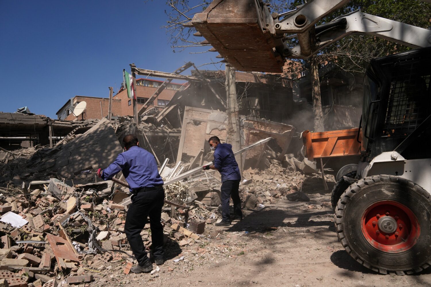 Workers remove debris at Tehran's Sharif University of Technology complex that Iranian authorities ...