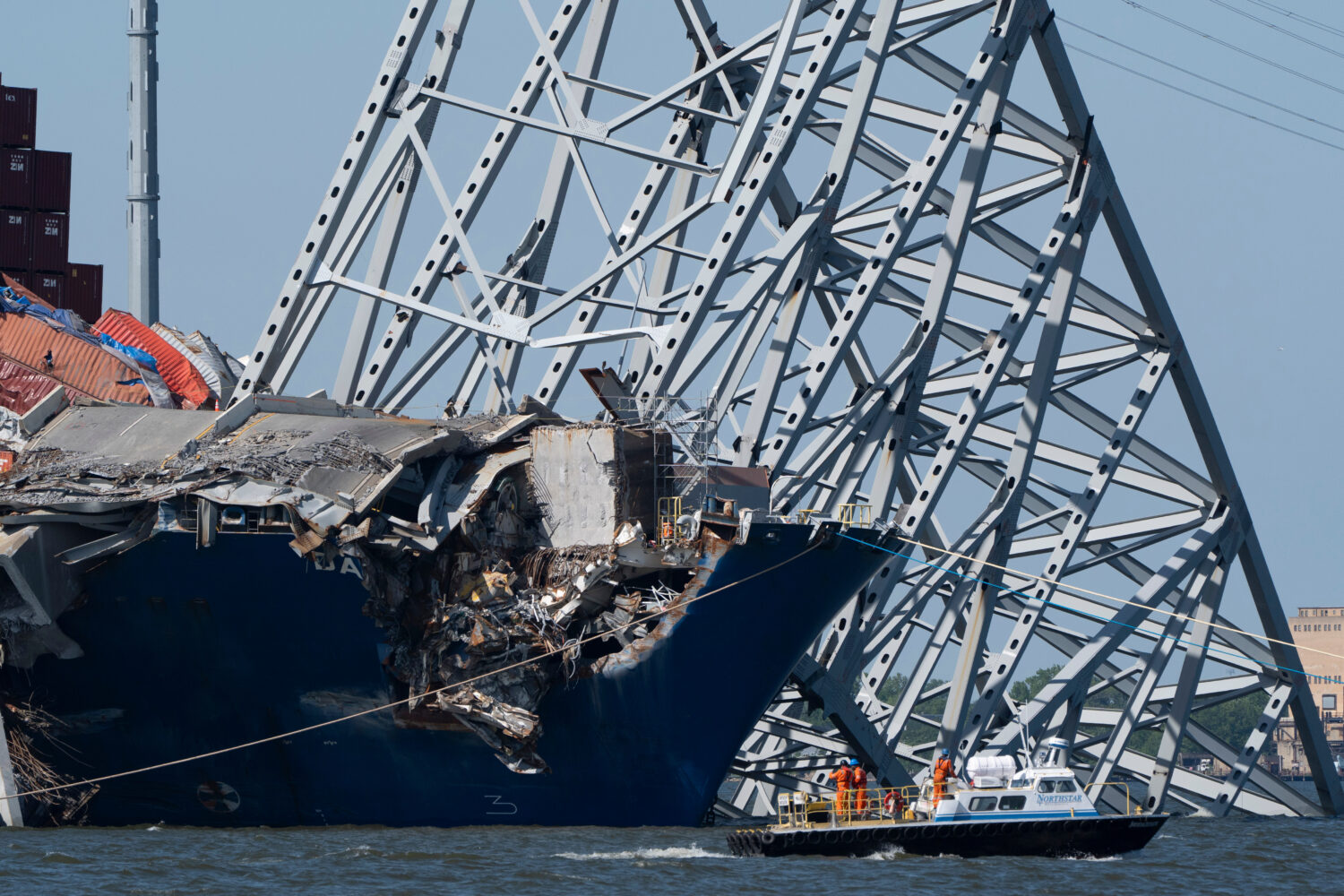FILE - A boat moves past the bow of the container ship Dali prior to the detonation of explosive ch...
