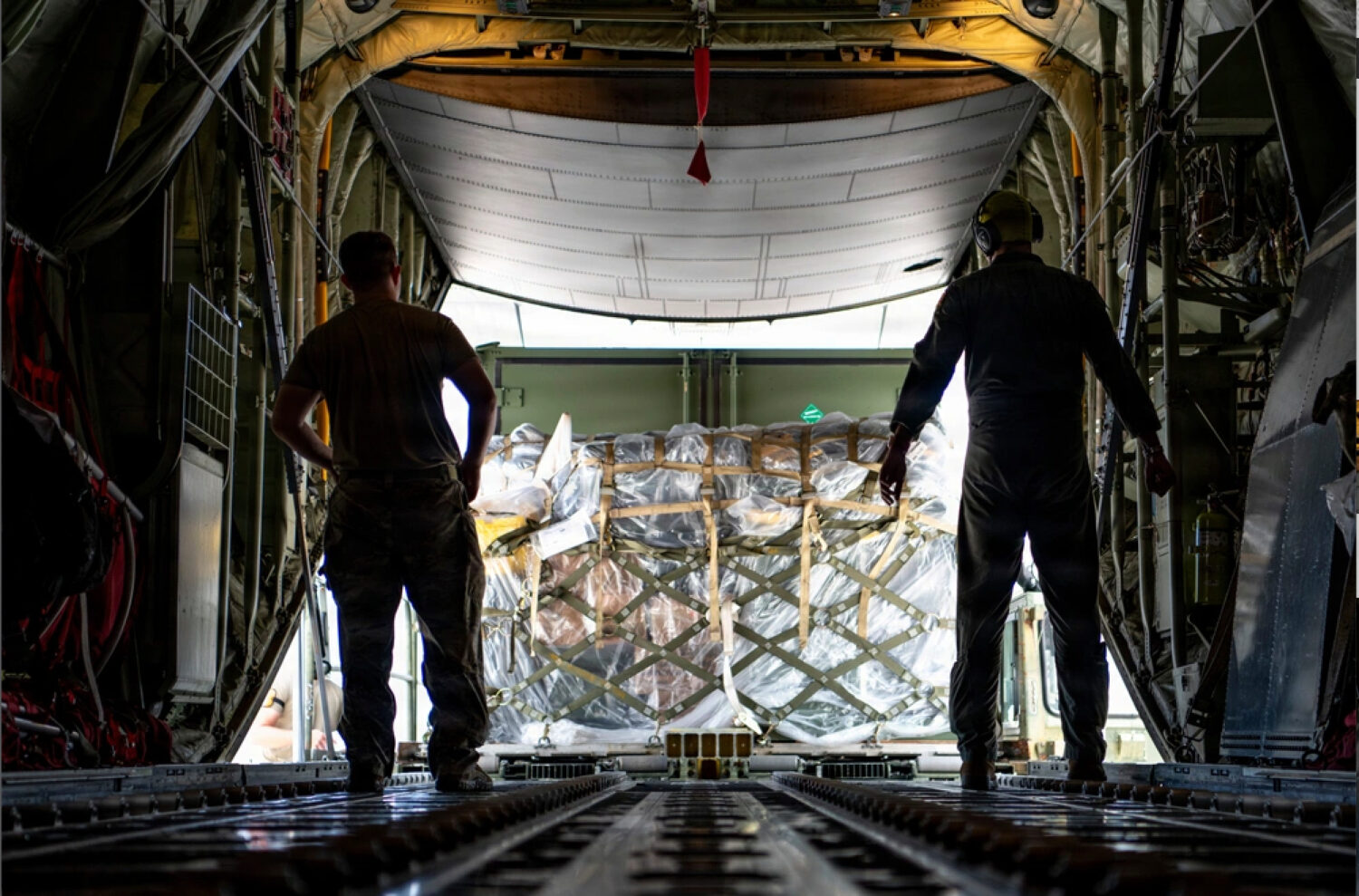 This photo provided by U.S. Air Force, U.S. Air Force loadmasters assigned to the 36th Airlift Squa...