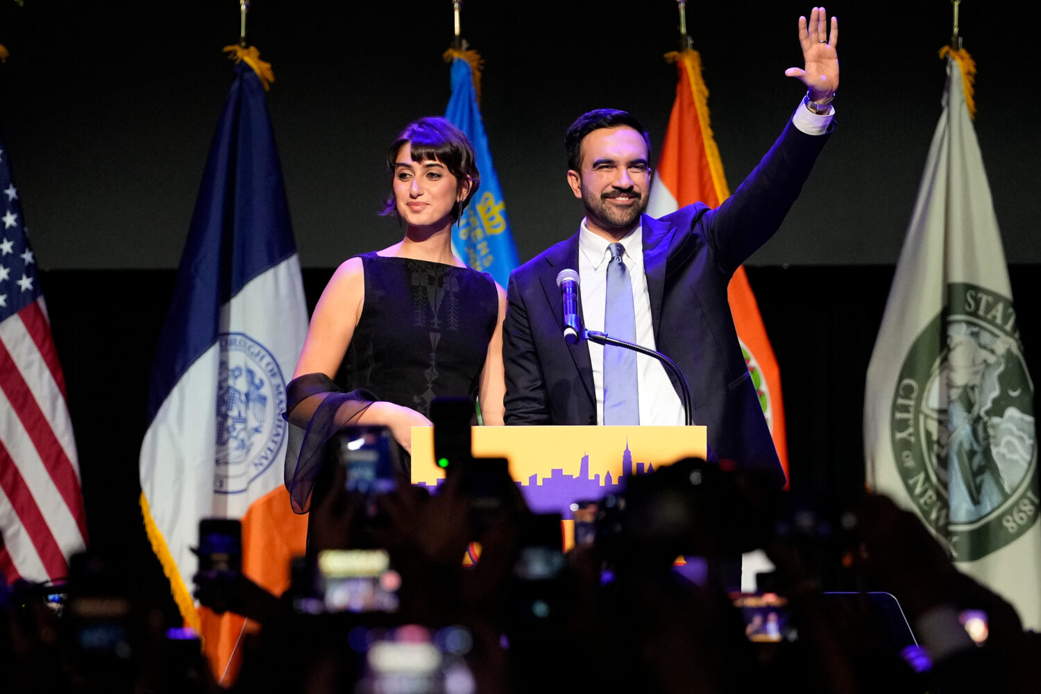 FILE - Mayor-elect Zohran Mamdani, right, and his wife, Rama Duwaji, react to supporters during an ...