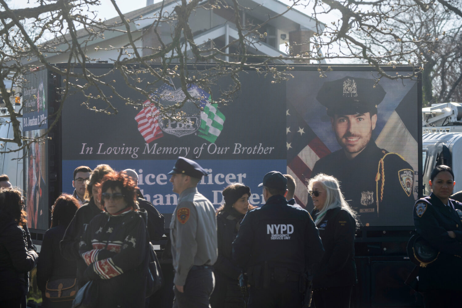 FILE - New York Police Department Officer Jonathan Diller is on a screen during his funeral service...