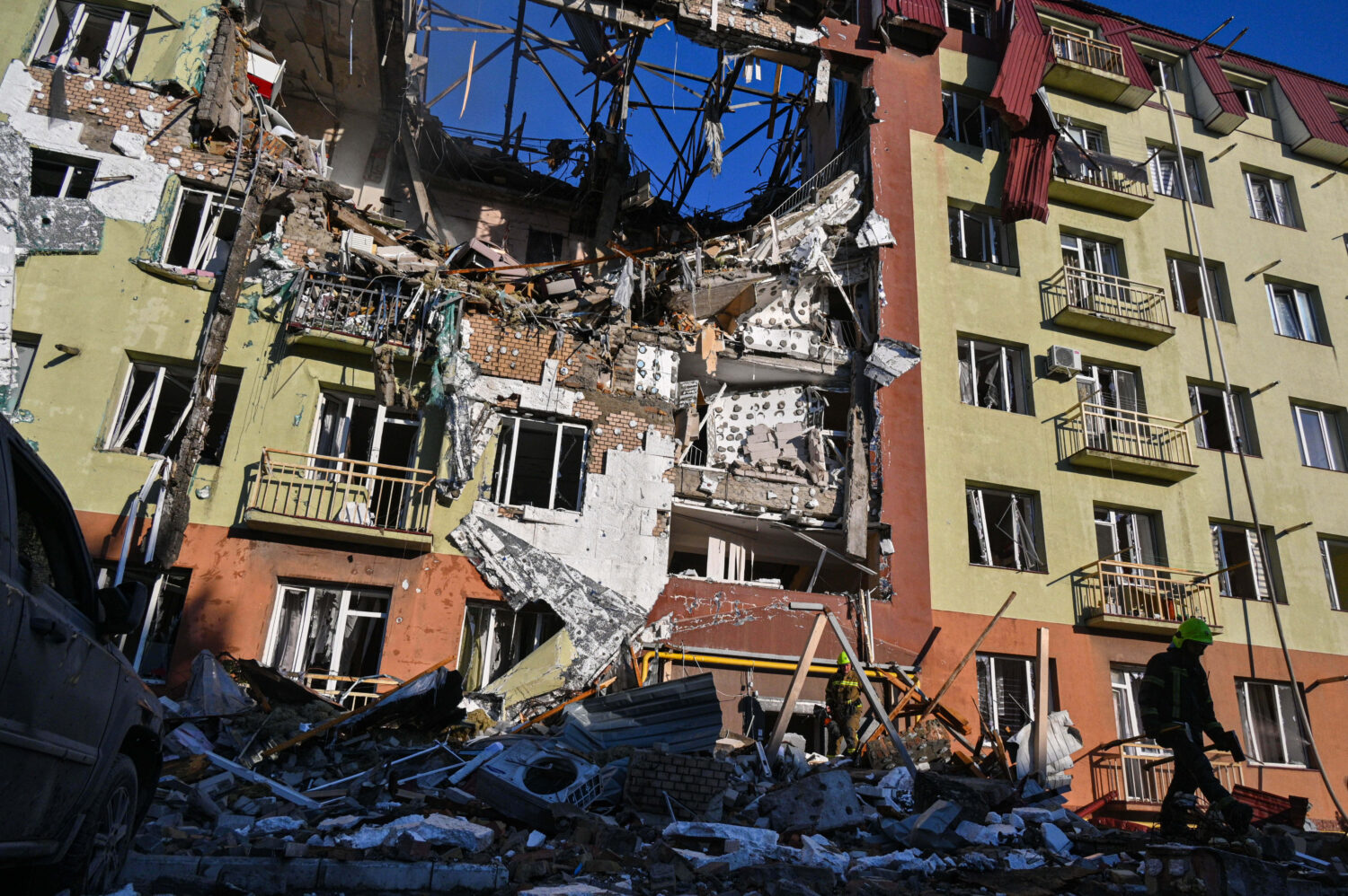 A rescue worker walks in front of residential building which was heavily damaged after a Russian st...